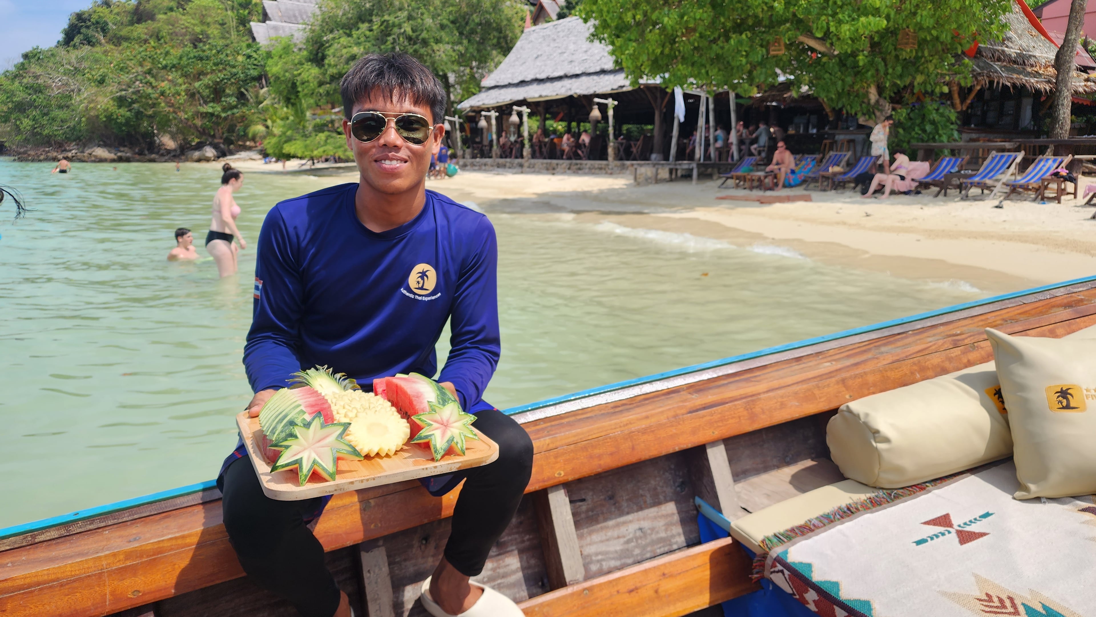 Phi Phi Islands Private Longtail Boat Tour - 02 thai boat captian offers fresh fruits to private tour customers
